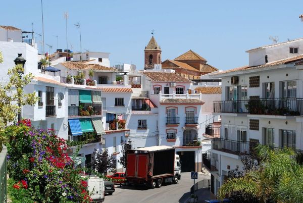 View along the main shopping street with the church to the rear, Torrox, Costa del Sol, Malaga.jpg